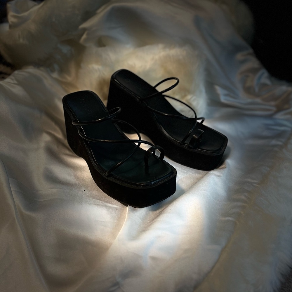 Black platform sandals with straps.